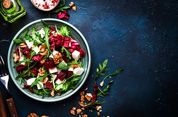 rocket, beet and feta cheese salad with red cabbage and walnuts